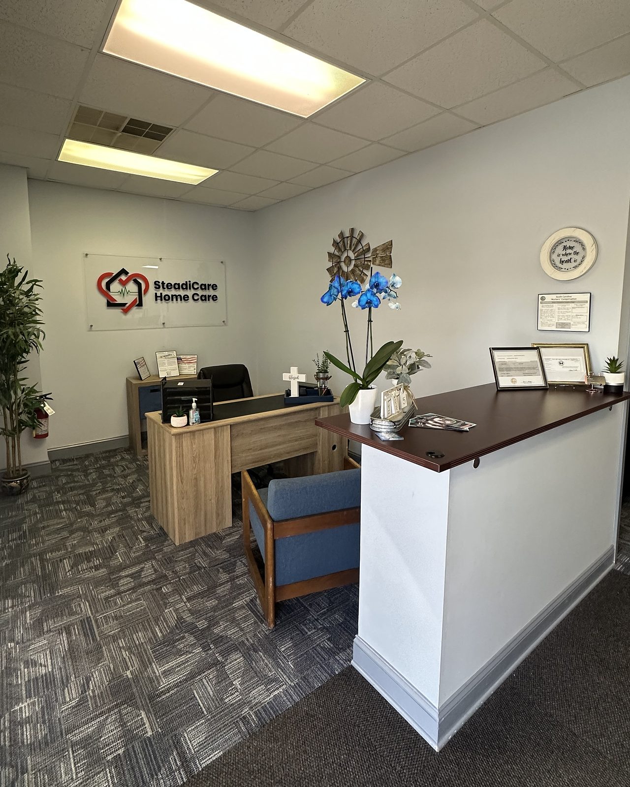The front-office reception at SteadiCare Home Care in Greenwood, South Carolina, with the SteadiCare logo on the wall